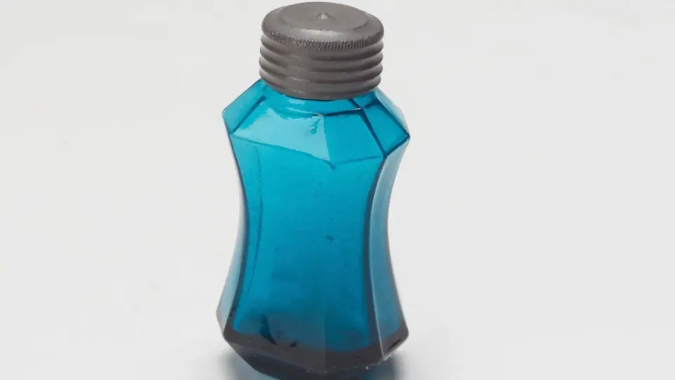 Un frasco de perfume bajo una luz suave